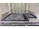 The kitchen island features a gas cooktop with a stainless steel kitchenaid logo at 3348 Perrington Pointe, Marietta, GA 30066