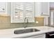 Modern kitchen with sleek countertops, a stainless steel sink, and white cabinetry at 3348 Perrington Pointe, Marietta, GA 30066