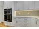 Modern kitchen features white cabinets, gray backsplash, stainless steel oven and quartz countertops at 3348 Perrington Pointe, Marietta, GA 30066