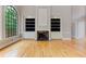 Living room featuring a fireplace with built-in bookshelves and large windows at 3348 Perrington Pointe, Marietta, GA 30066