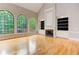 Living room featuring tall windows, hardwood floors, and built-in bookcases at 3348 Perrington Pointe, Marietta, GA 30066