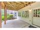 Covered patio with string lights, with access to the house through a white door and windows at 3348 Perrington Pointe, Marietta, GA 30066