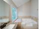 Bathroom showcasing a soaking tub with tile surround, a vanity, and a window at 3480 Stillridge Dr, Alpharetta, GA 30022
