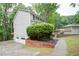 Exterior view of home with two-car garage and mature landscaping at 3480 Stillridge Dr, Alpharetta, GA 30022