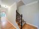 A well lit hallway features wood floors and a carpeted staircase at 3480 Stillridge Dr, Alpharetta, GA 30022