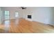 Spacious living room with hardwood floors, a white fireplace, and plenty of natural light at 3480 Stillridge Dr, Alpharetta, GA 30022