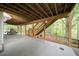 View of covered under deck with exposed rafters and stairs leading to backyard at 3480 Stillridge Dr, Alpharetta, GA 30022