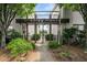 Condominium entrance behind wrought iron gate with manicured landscaping and signage at 3501 Roswell Ne Rd # 102, Atlanta, GA 30305