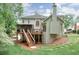Backyard with deck, screened porch, and lush green lawn at 9900 Hunt Club Way, Johns Creek, GA 30022