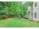 Expansive backyard featuring lush lawn and mature trees, ideal for outdoor enjoyment and relaxation at 9900 Hunt Club Way, Johns Creek, GA 30022