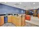 Finished basement with a built-in wet bar and comfortable leather seating area at 9900 Hunt Club Way, Johns Creek, GA 30022