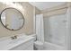 Updated bathroom featuring a modern mirror, vanity, and shower with bathtub at 9900 Hunt Club Way, Johns Creek, GA 30022