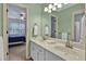 Bathroom features double sinks, mirrors, and well-lit vanity for a modern feel at 9900 Hunt Club Way, Johns Creek, GA 30022