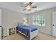 This bedroom offers natural light, ceiling fan, and neutral walls to bring warmth at 9900 Hunt Club Way, Johns Creek, GA 30022