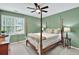 Cozy bedroom featuring a ceiling fan and window views at 9900 Hunt Club Way, Johns Creek, GA 30022