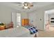 This bedroom offers natural light, ceiling fan, and neutral walls to bring warmth at 9900 Hunt Club Way, Johns Creek, GA 30022