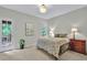 Bedroom with neutral walls, natural light, cozy decor and access to an outdoor deck at 9900 Hunt Club Way, Johns Creek, GA 30022
