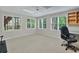 Bright bedroom featuring three windows with natural light and a ceiling fan at 9900 Hunt Club Way, Johns Creek, GA 30022