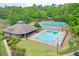 Aerial view of a community clubhouse with pool, tennis court, and playground at 9900 Hunt Club Way, Johns Creek, GA 30022