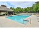 Community swimming pool with lounge chairs and shady areas at 9900 Hunt Club Way, Johns Creek, GA 30022