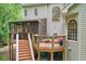 Wooden deck and screened-in porch overlooking a well-maintained backyard, creating a serene outdoor space at 9900 Hunt Club Way, Johns Creek, GA 30022