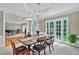 Dining area adjacent to living room with large table, french doors, and chandelier at 9900 Hunt Club Way, Johns Creek, GA 30022