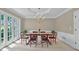 Elegant dining room featuring a chandelier, large windows, and a classic dining set at 9900 Hunt Club Way, Johns Creek, GA 30022