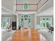 Spacious foyer with hardwood floors, high ceilings, and large glass windows offering natural light at 9900 Hunt Club Way, Johns Creek, GA 30022