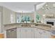 An open concept kitchen featuring granite countertops, stainless steel appliances, and hardwood flooring at 9900 Hunt Club Way, Johns Creek, GA 30022