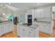 Modern kitchen featuring white cabinetry, granite countertops, and stainless steel appliances, and hardwood flooring at 9900 Hunt Club Way, Johns Creek, GA 30022
