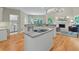 Open concept kitchen with granite countertops, stainless steel appliances, and hardwood floors at 9900 Hunt Club Way, Johns Creek, GA 30022