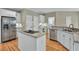 Bright kitchen with stainless steel appliances, granite countertops, and a kitchen island with a smooth cooktop at 9900 Hunt Club Way, Johns Creek, GA 30022