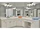 Large main bathroom featuring dual vanity, white cabinets, and a vanity area at 9900 Hunt Club Way, Johns Creek, GA 30022