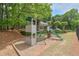 Community playground area with climbing structure, slide, and mulch ground cover at 9900 Hunt Club Way, Johns Creek, GA 30022