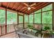 Relaxing screened porch with wood ceiling, ceiling fan, and comfortable seating at 9900 Hunt Club Way, Johns Creek, GA 30022
