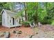 Charming backyard featuring a small outbuilding and outdoor seating at 1518 Rochelle Dr, Atlanta, GA 30338
