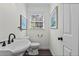 Bright bathroom with a sink, toilet, and a window at 1518 Rochelle Dr, Atlanta, GA 30338