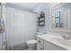Well-lit bathroom with a shower, vanity, and decorative shelving at 1518 Rochelle Dr, Atlanta, GA 30338