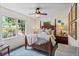 Comfortable bedroom featuring a four-poster bed, ceiling fan, a window and a decorative rug at 1518 Rochelle Dr, Atlanta, GA 30338