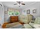 Bedroom with neutral tones, hardwood floors, and backyard window at 1518 Rochelle Dr, Atlanta, GA 30338
