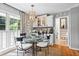 Bright dining area featuring a glass table, bright light fixture and view to the backyard at 1518 Rochelle Dr, Atlanta, GA 30338