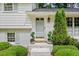 Inviting front entrance with white brick, potted greenery, and stylish light fixture enhancing the home's appeal at 1518 Rochelle Dr, Atlanta, GA 30338