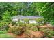 Well-maintained home with beautifully landscaped front yard featuring colorful flowers and lush greenery at 1518 Rochelle Dr, Atlanta, GA 30338