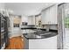 Modern kitchen with stainless steel appliances, a gas cooktop, and white cabinetry providing ample storage at 1518 Rochelle Dr, Atlanta, GA 30338