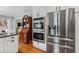 Well-lit kitchen featuring stainless steel appliances, white cabinets, and a vintage display cabinet at 1518 Rochelle Dr, Atlanta, GA 30338