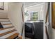 Laundry room and stairs featuring modern washer, dryer, and exterior views at 1518 Rochelle Dr, Atlanta, GA 30338