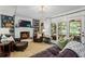 Comfortable living room showcasing a brick fireplace, shelves, and doors to an outdoor space at 1518 Rochelle Dr, Atlanta, GA 30338