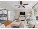 Inviting living room with hardwood floors, a large TV, and a seamless flow into the adjacent kitchen at 1518 Rochelle Dr, Atlanta, GA 30338