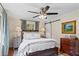 Comfortable main bedroom featuring a ceiling fan, hardwood floors and backyard views at 1518 Rochelle Dr, Atlanta, GA 30338
