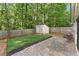 Spacious backyard with a patio, shed, and lawn, perfect for outdoor entertaining and recreation at 171 Nacoochee Way, Canton, GA 30114